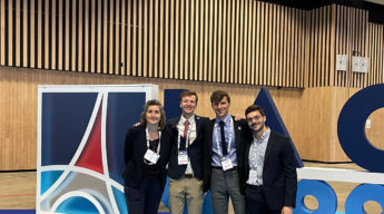 eSpace team in front of the IAC logo